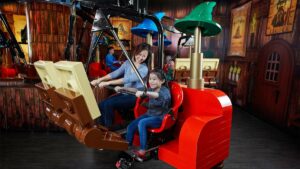 Close up of a mother and daughter on the Merlin’s Apprentice Ride at the LEGOLAND Discovery Center in Chicago, Illinois, USA